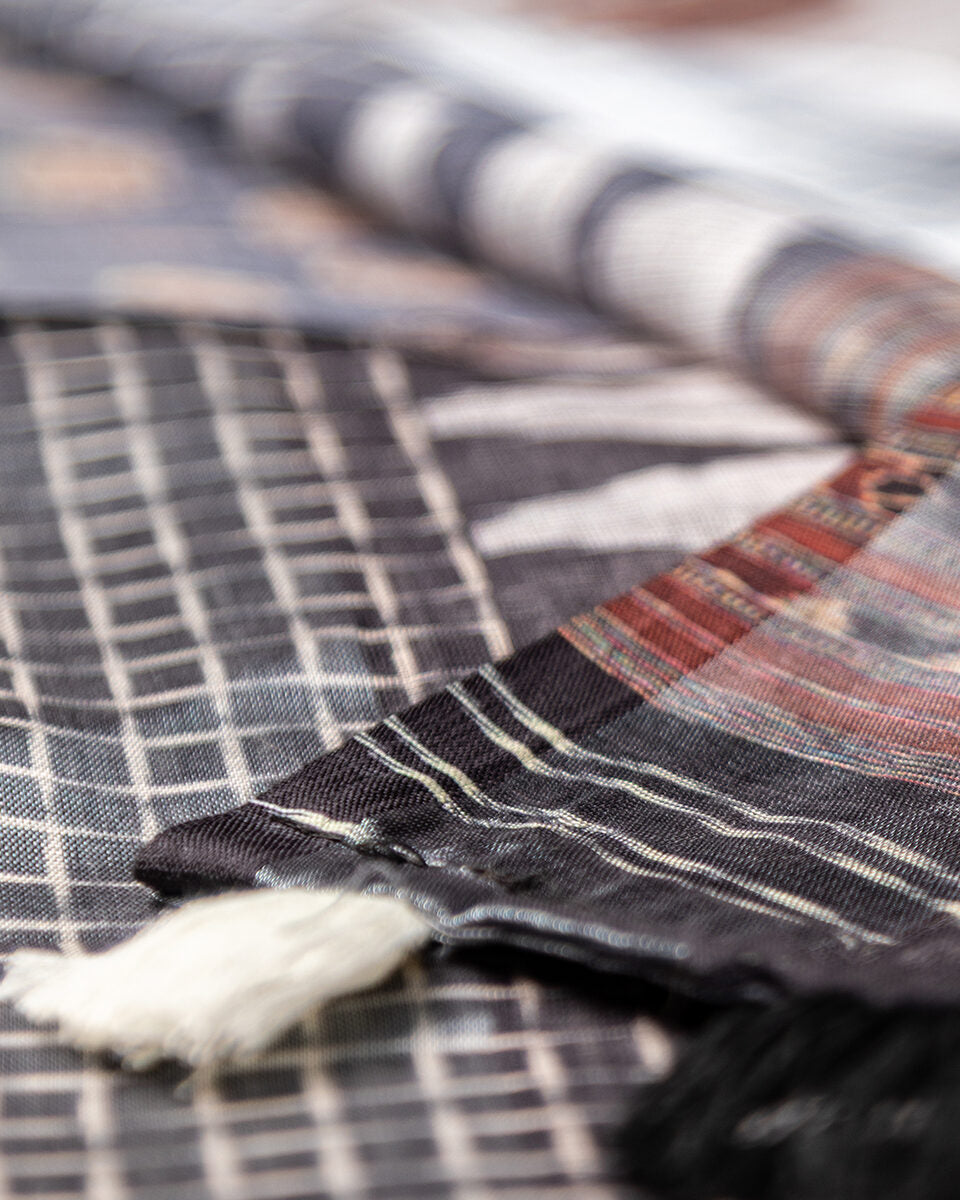 Detailed view of the striped pallu and white tassel accents on the Grey Cotton Saree by Rajathee Saree.