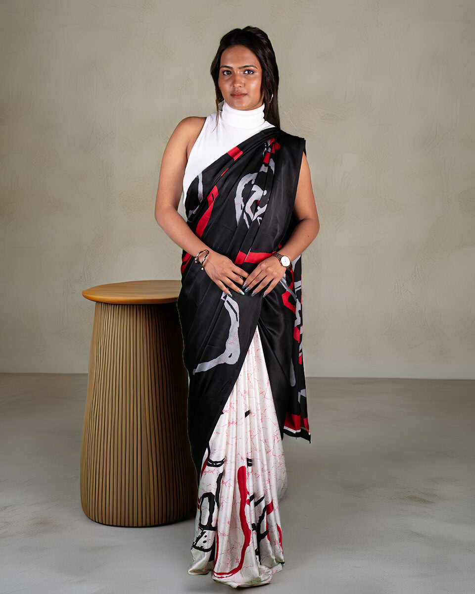 Full-length shot of a white and black abstract print saree with red highlights, styled for a sleek, contemporary look.